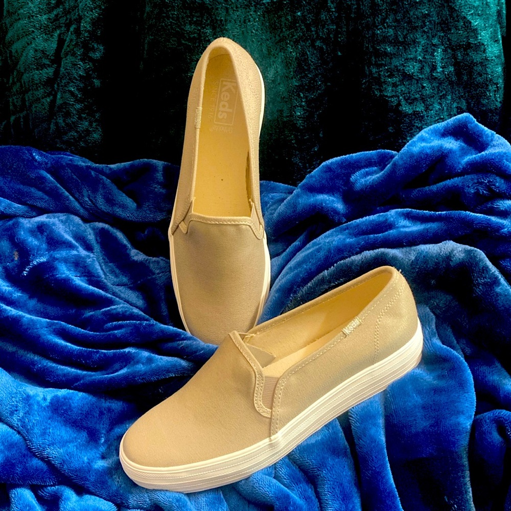 Keds slip on sneaker. Tan color with gold metallic tone. Never been worn.